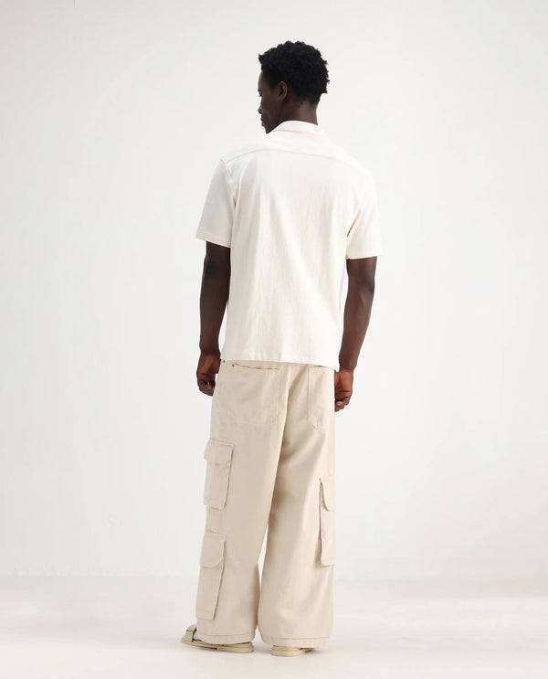 Rare Rabbit Men's Freks Beige Cotton Fabric Button And Zip Closure Baggy Fit Plain Jeans