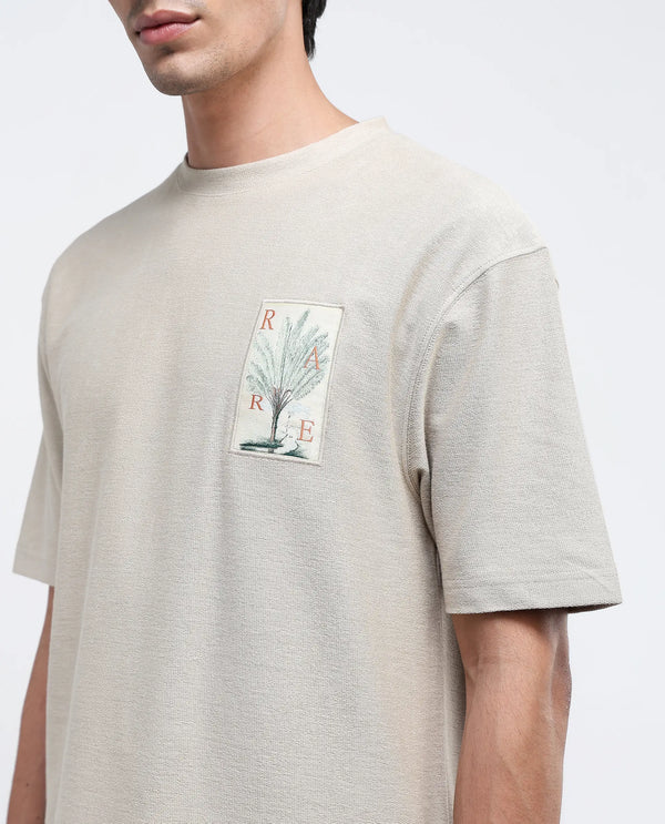 Rare Rabbit Men's Loopet Beige Cotton Lycra Fabric Half Sleeves Floral Print Pocket Detailing Oversized Fit Solid T-Shirt