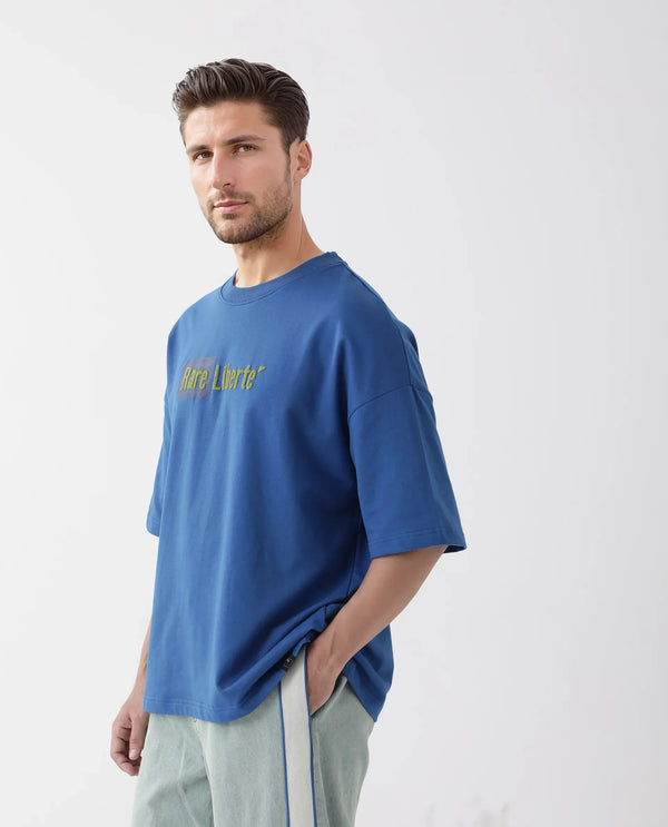 Rare Rabbit Men Moshe Flouroscent Blue Cotton Fabric Short Sleeve Oversized Fit Graphic Printed T-Shirt