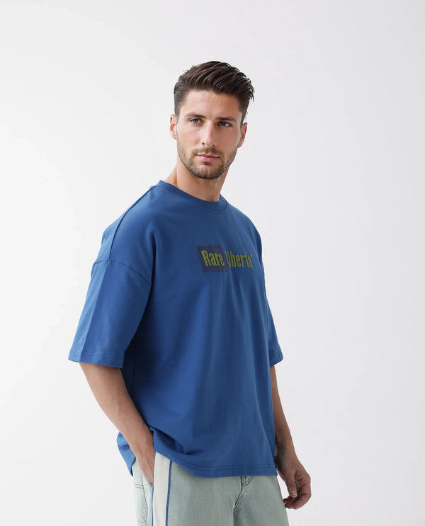Rare Rabbit Men Moshe Flouroscent Blue Cotton Fabric Short Sleeve Oversized Fit Graphic Printed T-Shirt