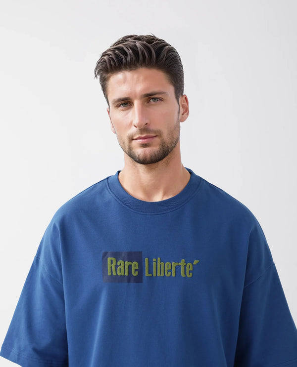 Rare Rabbit Men Moshe Flouroscent Blue Cotton Fabric Short Sleeve Oversized Fit Graphic Printed T-Shirt