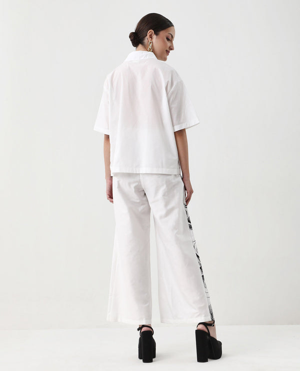 Rareism Women Neilsono White Cotton Satin Fabric Tie-Up Closure Flared Fit Ankle Length Floral Print Trouser