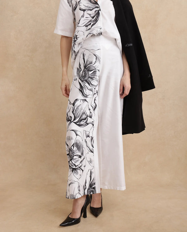 Rareism Women Neilsono White Cotton Satin Fabric Tie-Up Closure Flared Fit Ankle Length Floral Print Trouser