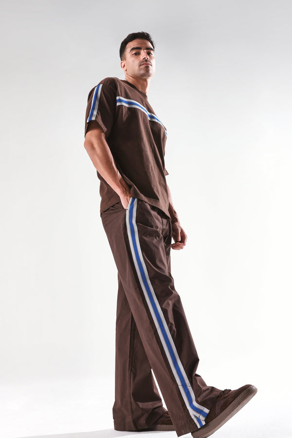 Rare Rabbit Men Newnon Brown Cotton Fabric Mid Rise Baggy Fit Side Slit with Snap Button Closure Tape Detailing Track Pant