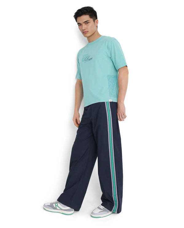 Rare Rabbit Men Newnon Navy Cotton Fabric Mid Rise Baggy Fit Side Slit with Snap Button Closure Tape Detailing Track Pant