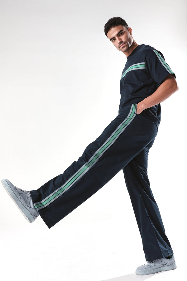 Rare Rabbit Men Newnon Navy Cotton Fabric Mid Rise Baggy Fit Side Slit with Snap Button Closure Tape Detailing Track Pant