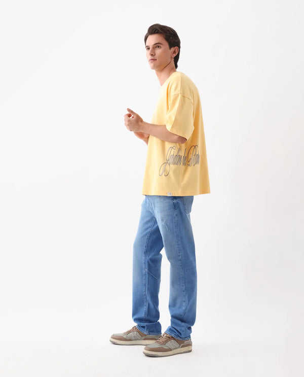 Rare Rabbit Men Siwa Light Yellow Cotton Fabric Short Sleeve Slip-On Oversized Fit Graphic Print T-Shirt
