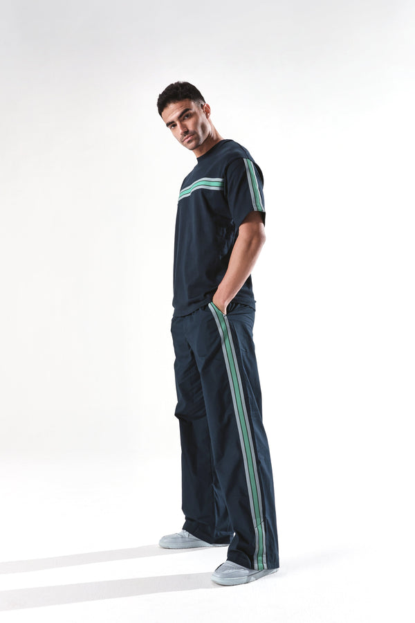 Rare Rabbit Men Newnon Navy Cotton Fabric Mid Rise Baggy Fit Side Slit with Snap Button Closure Tape Detailing Track Pant