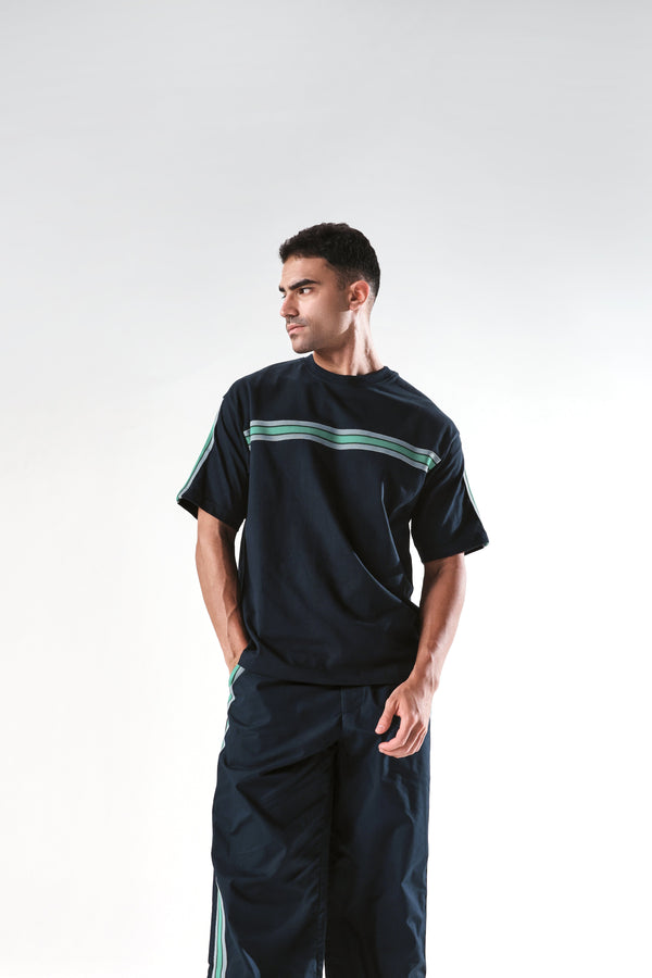 Rare Rabbit Men Newnon Navy Cotton Fabric Mid Rise Baggy Fit Side Slit with Snap Button Closure Tape Detailing Track Pant
