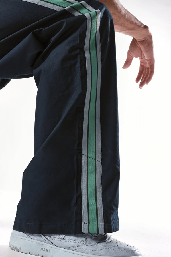 Rare Rabbit Men Newnon Navy Cotton Fabric Mid Rise Baggy Fit Side Slit with Snap Button Closure Tape Detailing Track Pant