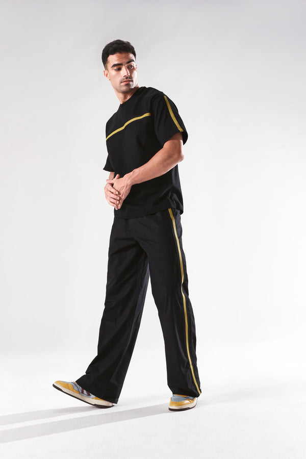Rare Rabbit Men Newnon Black Cotton Fabric Mid Rise Baggy Fit Side Slit with Snap Button Closure Tape Detailing Track Pant